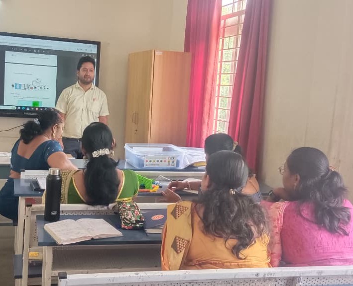 Trainer explaining robotics concepts to teachers