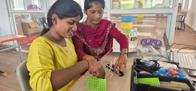 Teachers assembling a robotics project
